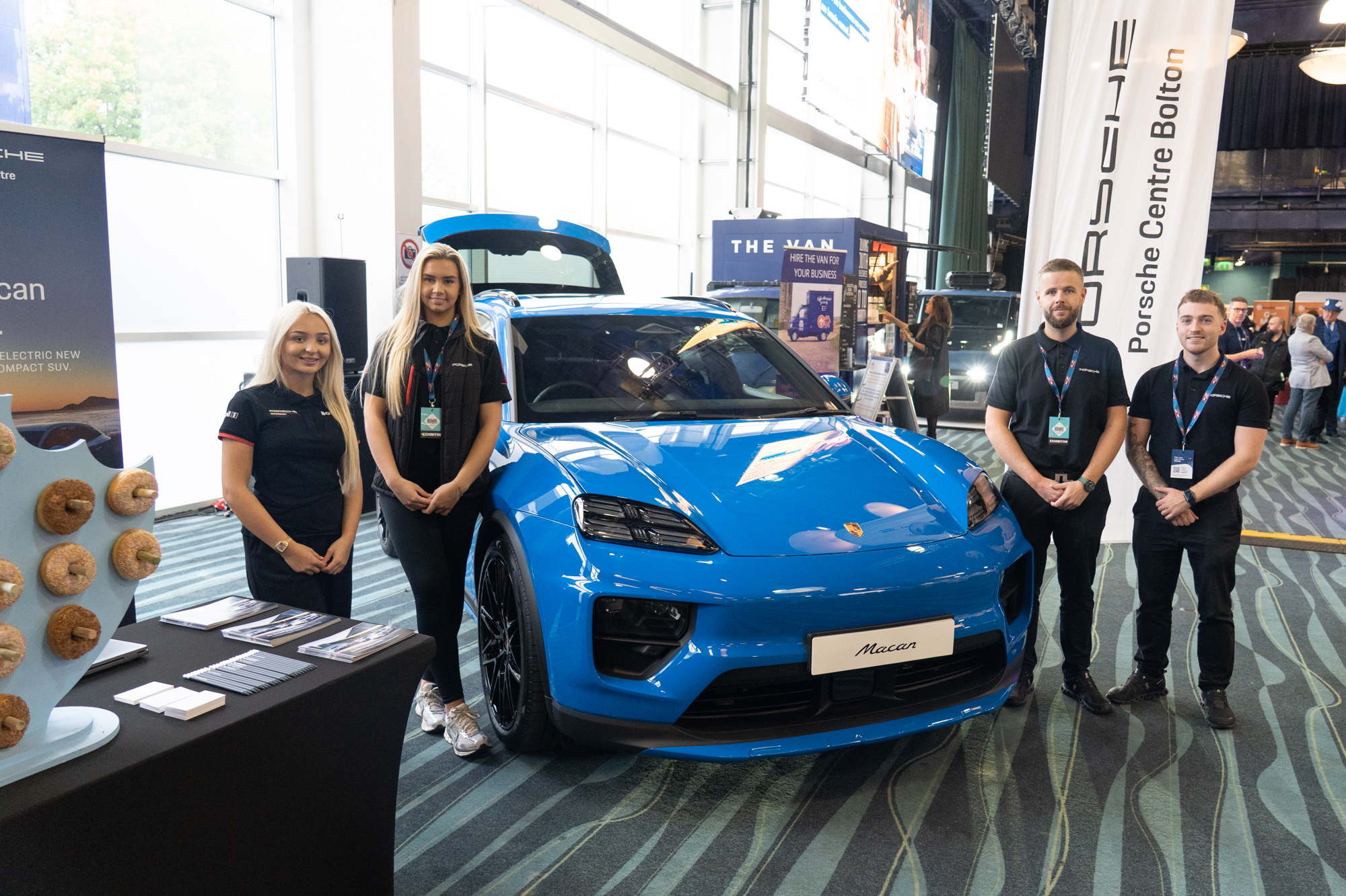Staff beside a Porsche vehicle at a previous North West expo